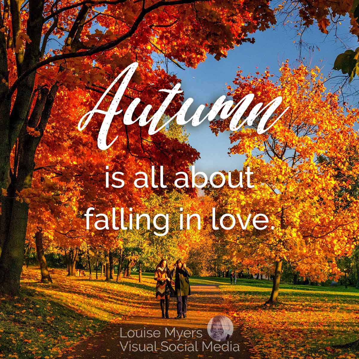 couple walking among fall color trees says autumn is all about falling in love.