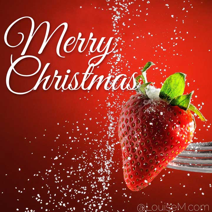 merry christmas script on red strawberry with sugar snow.