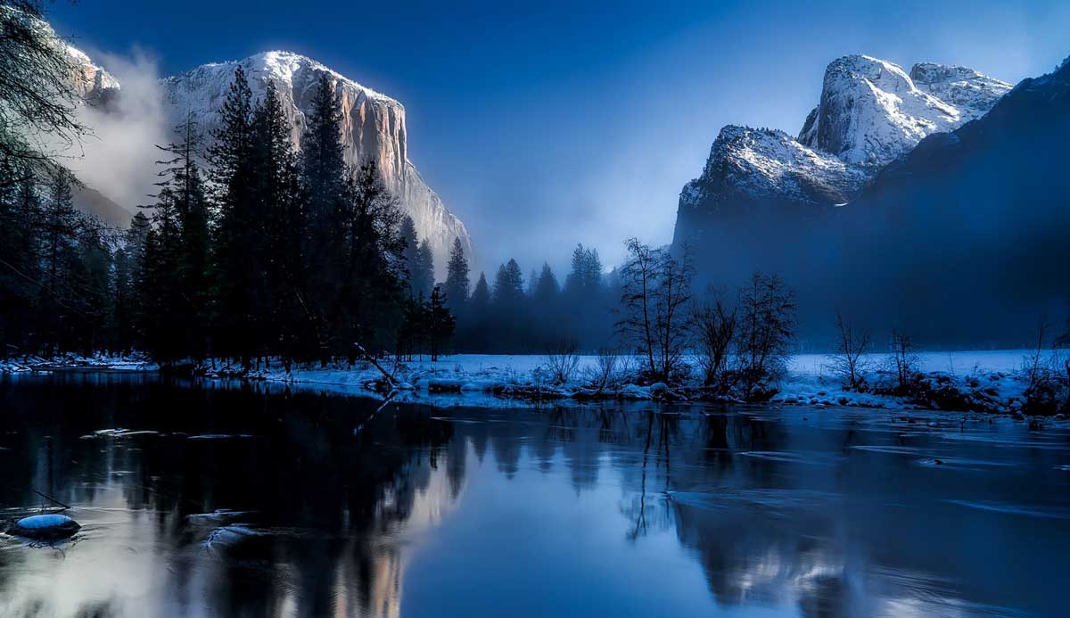 photo of snowy mountains and thawed lake.