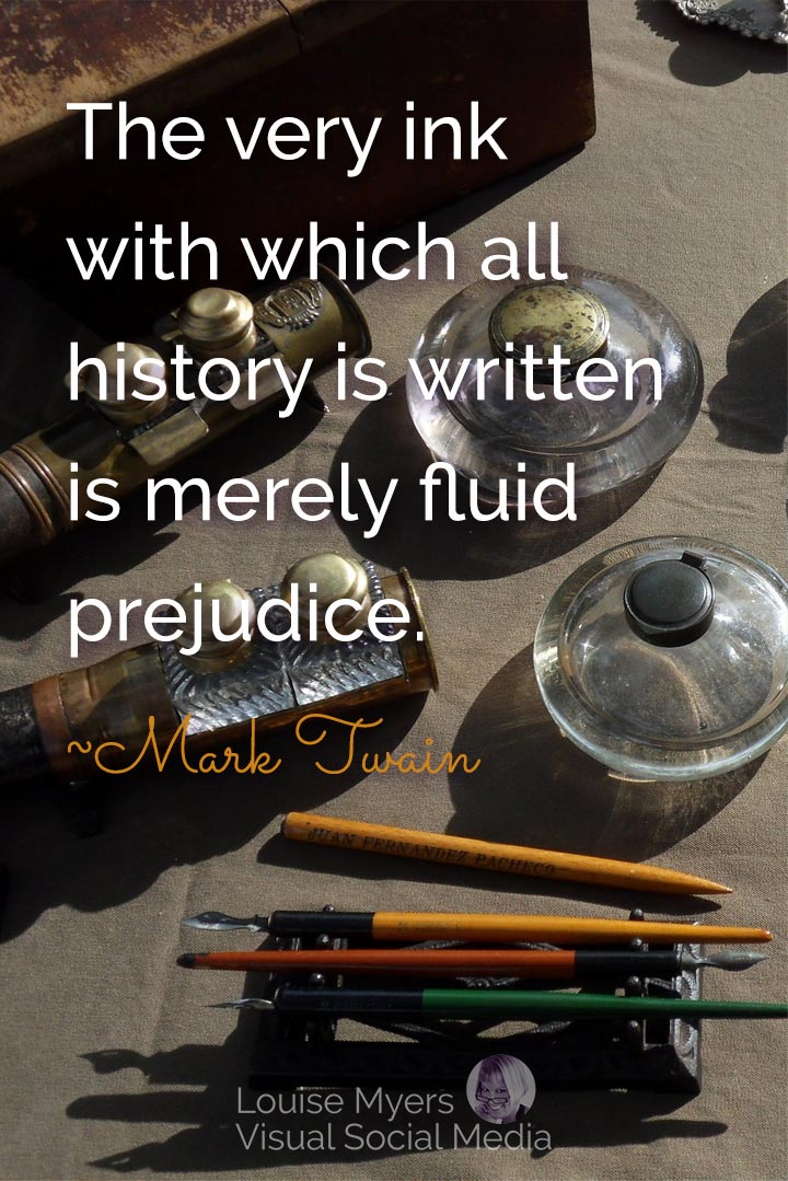 closeup of old pens and inkwells has Twain quote, the ink of history is fluid prejudice.