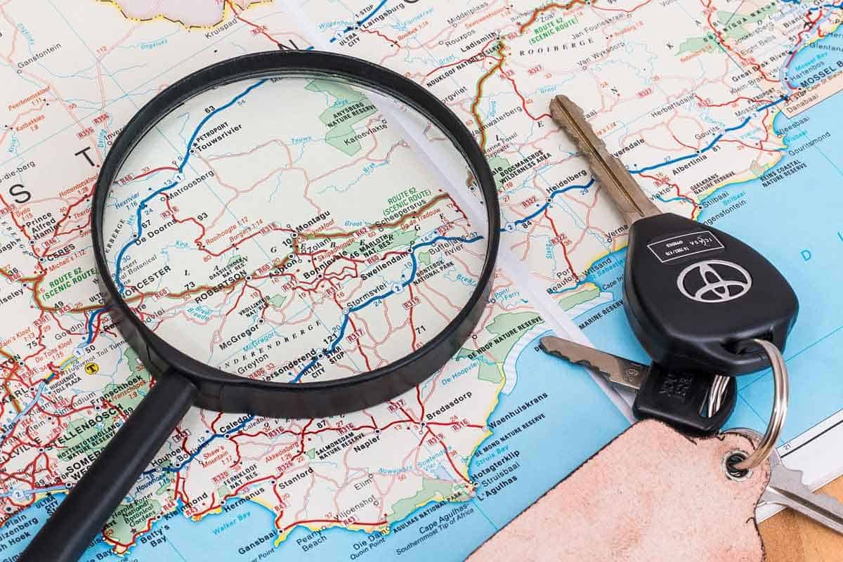 map with car keys and magnifying glass on it.