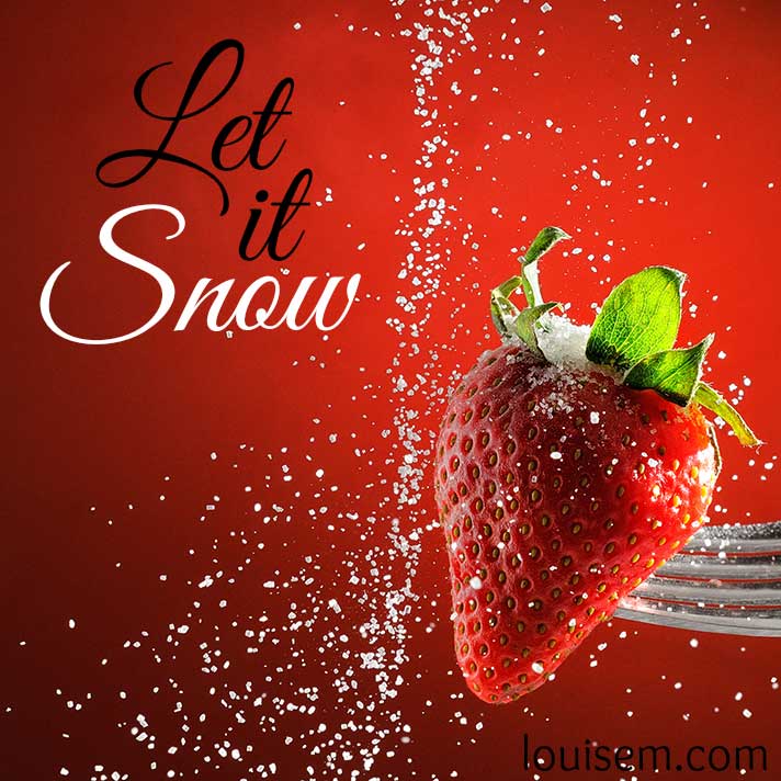 let it snow quote on red strawberry background.