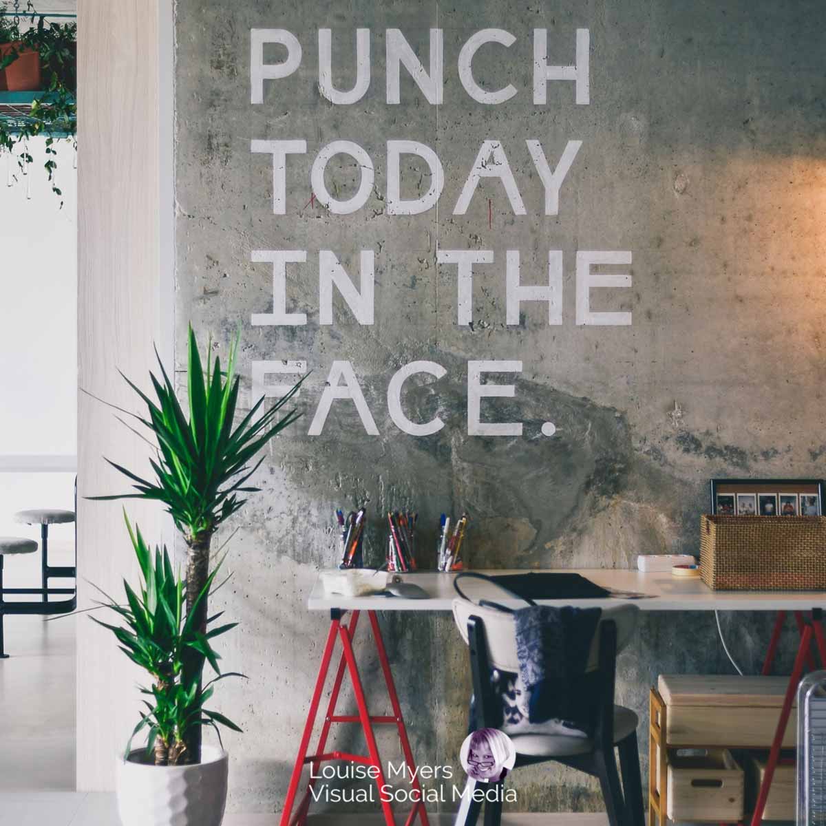 concrete wall in cafe has words painted on it, Punch today in the face.